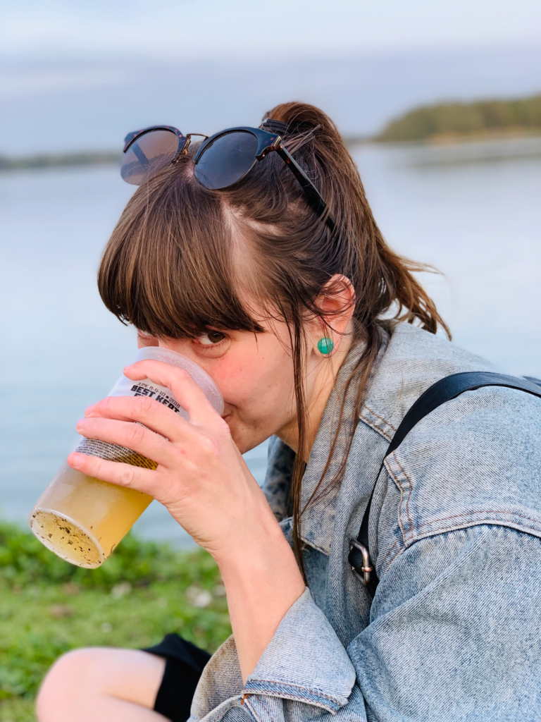 A portrait of Robin drinking beer at Best Kept Secret, a music festival